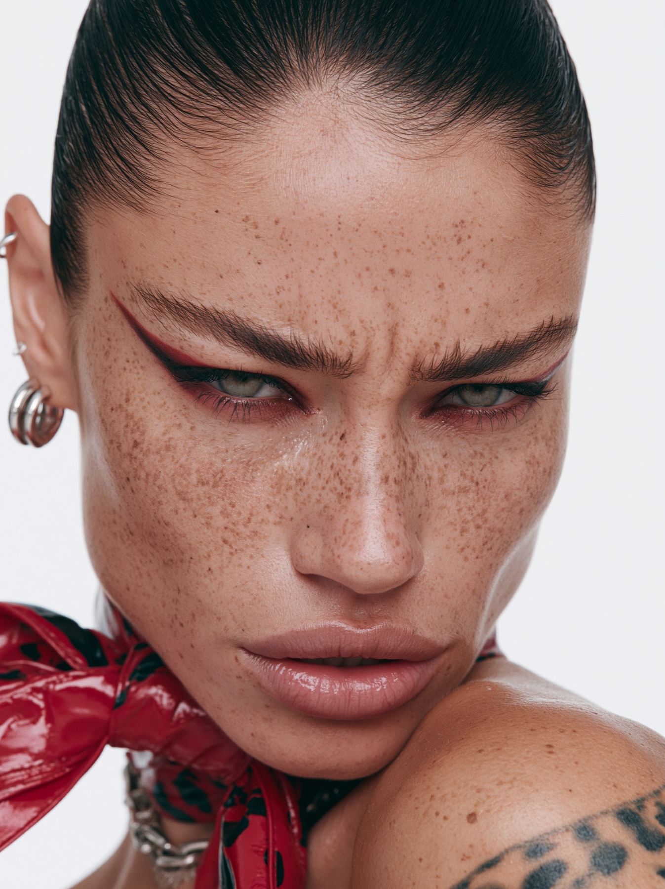 Beauty campaign close-up with graphic red eye makeup